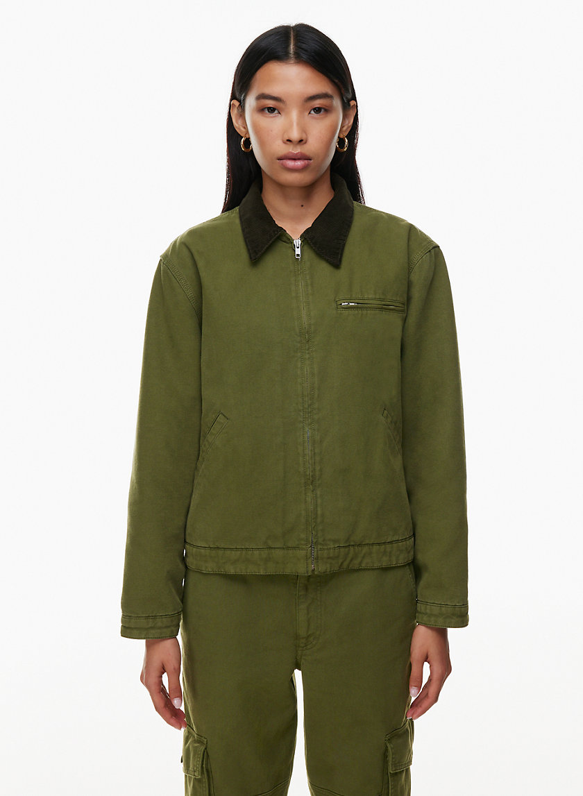 J. Crew olive green utility jacket worn over open denim shirt and