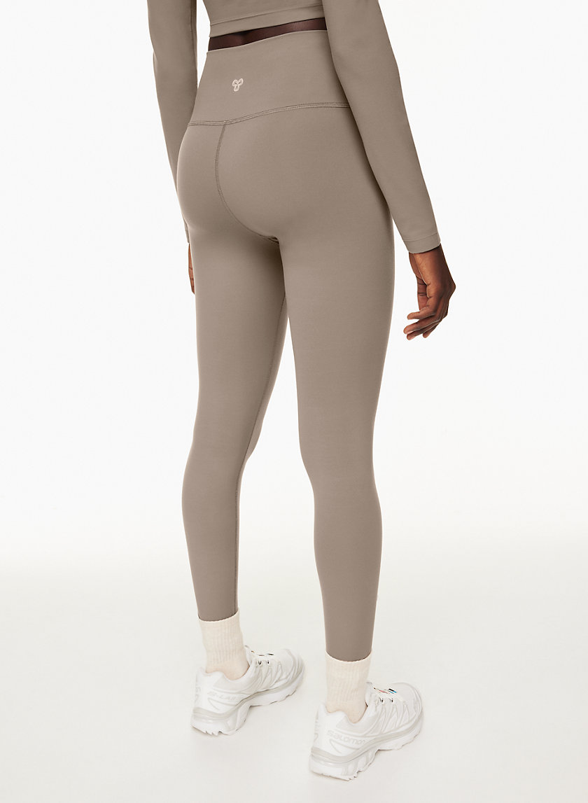 Premium Photo  A big woman booty in leggings on grey background.