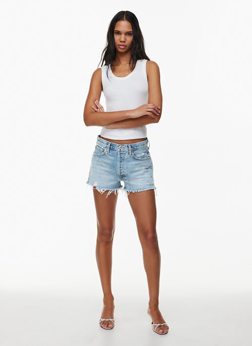 woman in denim shorts and pink sports bra body Stock Photo