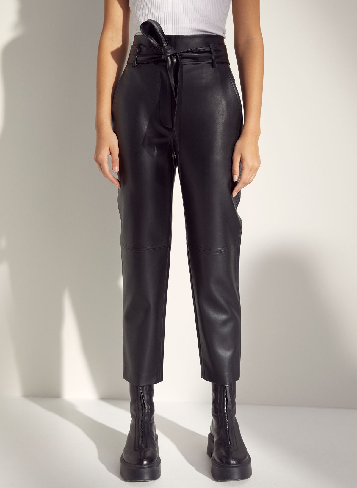 Love those high waisted belted tie black leather pants with trendy one  shoulder top.